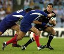 Daniel Carter of New Zealand tackled by France's Fabien Pelous and Christian Labit. 