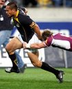 Hosea Gear of the Lions is tackled by Jimmy Cowan of Southland