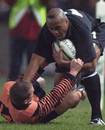 Jonah Lomu is tackled by Cameron Murray