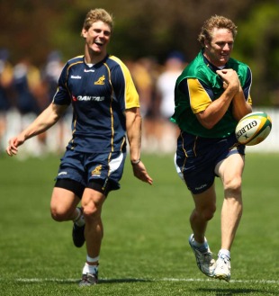 Australia centre Berrick Barnes sees the funny side in a mistake from Peter Hynes during training