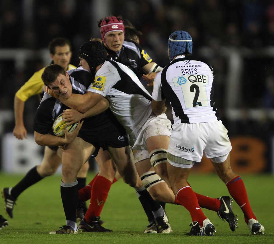 Newcastle's Mark Wilson battles with the Saracens defence