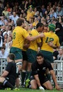 Australia fly-half Quade Cooper is mobbed after scoring