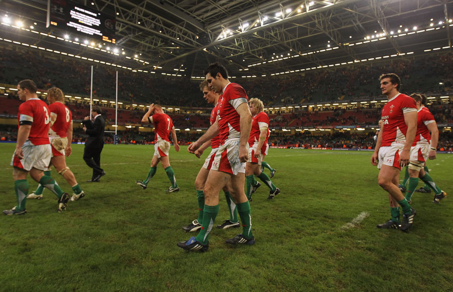 Wales' dejected players leave the pitch