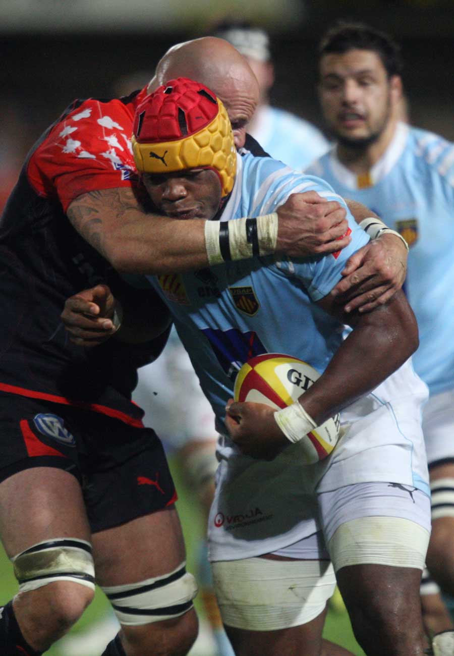 Perpignan's lock Robins Tchale-Watchou is tackled by Toulon's Kristian Chesney