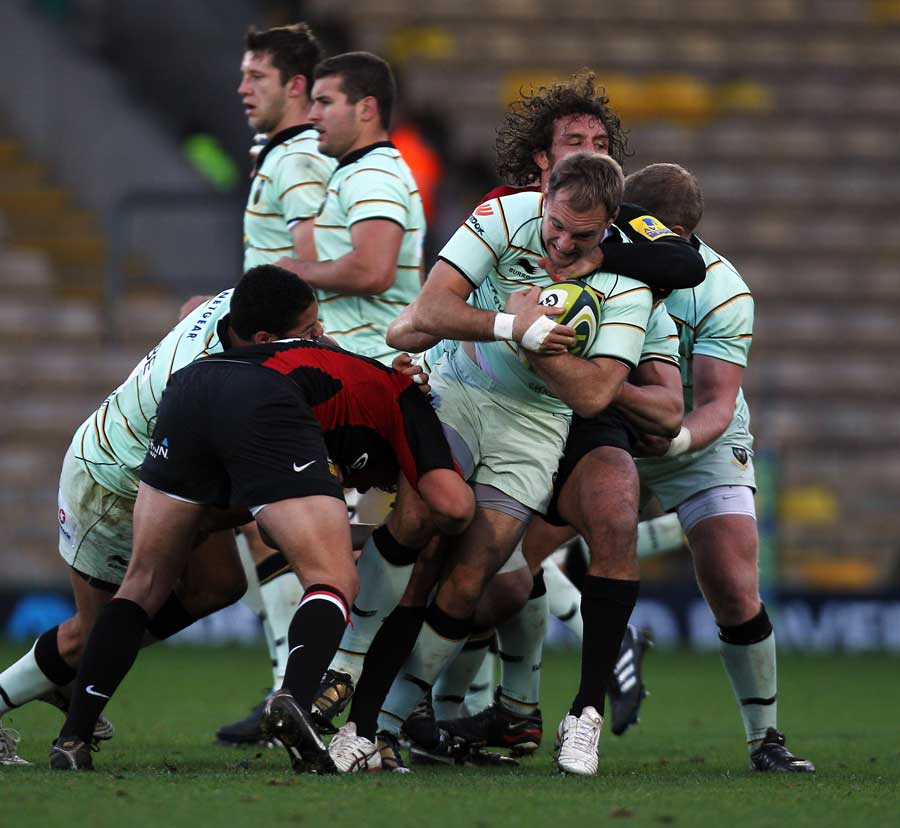 Northampton's Matt Cornwell is wrapped up by the Saracens defence