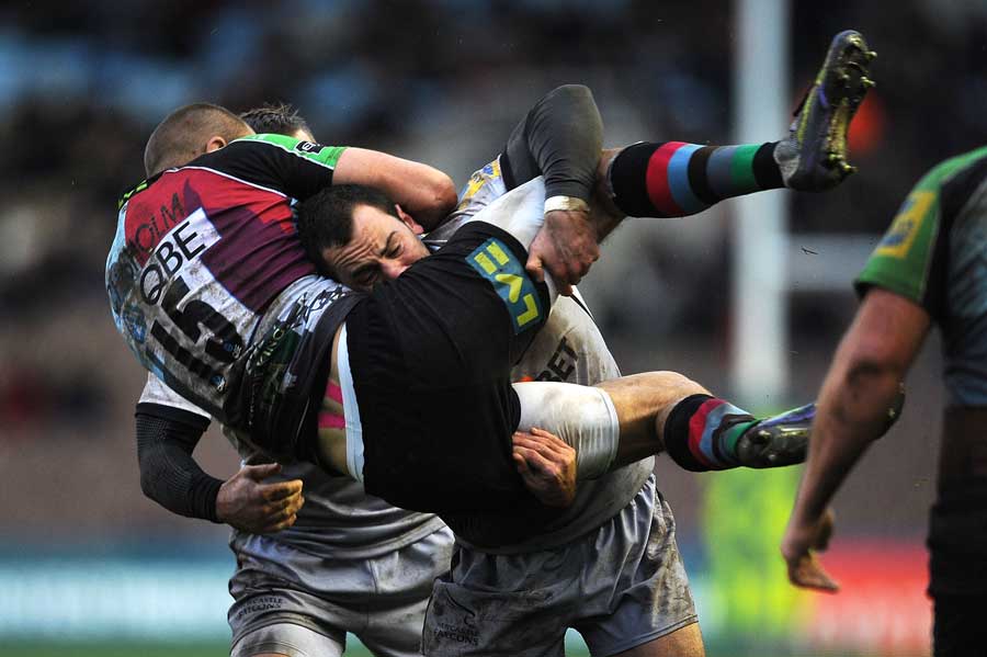 Harlequins' Ross Chisholm is hammered by Micky Young