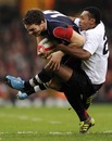 Wales' George North is tackled by Fiji's Taniela Rawaqa 