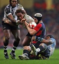 Wales' Ryan Jones is hauled down by the Fiji defence