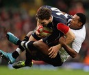 Wales' George North is tackled by Fiji's Taniela Rawaqa