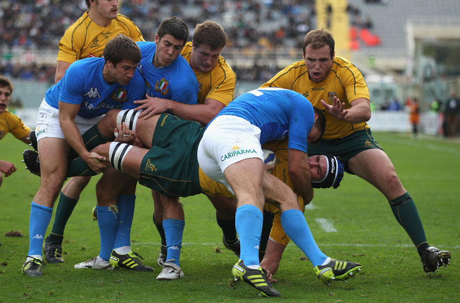 The Wallabies' Rob Simmons is held up by the Italian defence
