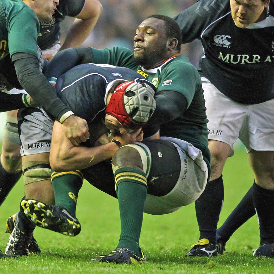 Scotland's Kelly Brown is tackled by South Africa's Tendai Mtawarira