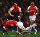 All Blacks fullback Mils Muliaina is wrapped up by the Welsh defence
