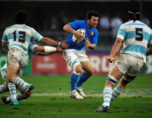 Italy fly-half Craig Gower evades a tackle