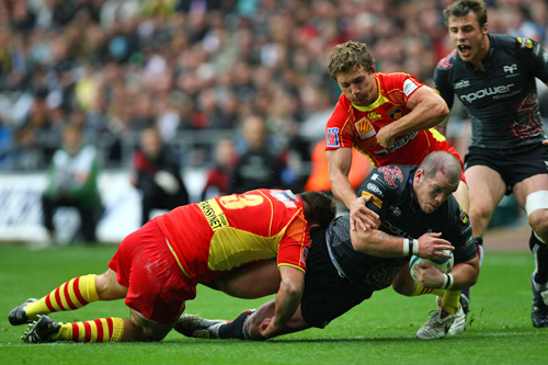Paul James of Ospreys is tackled 