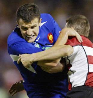 France centre Damien Traille struggles with the Japan defence, France v Japan, World Cup, Dairy Farmers Stadium, October 18 2003