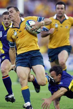 Mat Rogers breaks a Romanian tackle to score, Australia v Romania, World Cup, Lang Park, October 18 2003