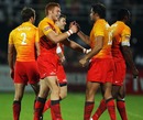 The England 7s team celebrate victory over Fiji