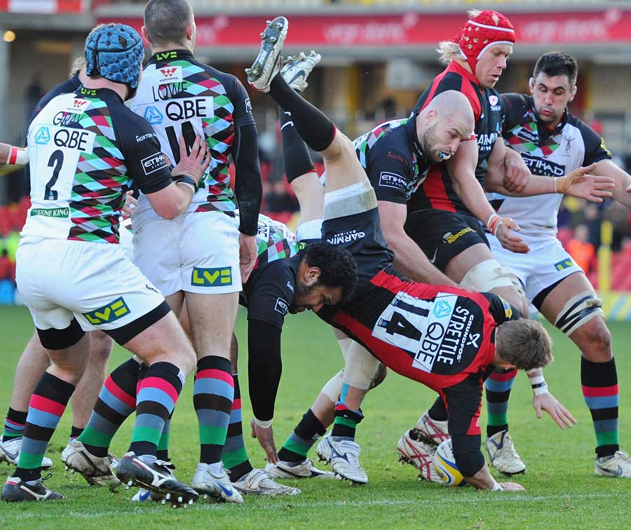 Saracens David Strettle is tackled by the Quins defence