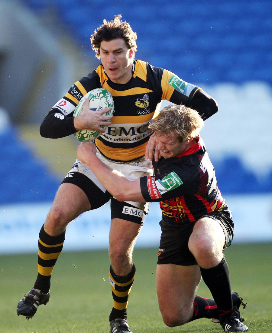 Wasps' Ben Jacobs is tackled by Dragon's Patrick Leah