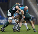 Toulon's Kris Chesney is hit by two London Irish defenders