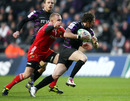 Ospreys' Barry Davies attempts to evade Keith Earls