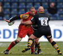 The Dragons' Gavin Thomas offloads behind his back against Wasps