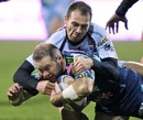 Stade Francais' Ollie Phillips is tackled by Bourgoin's Mickael Forest  