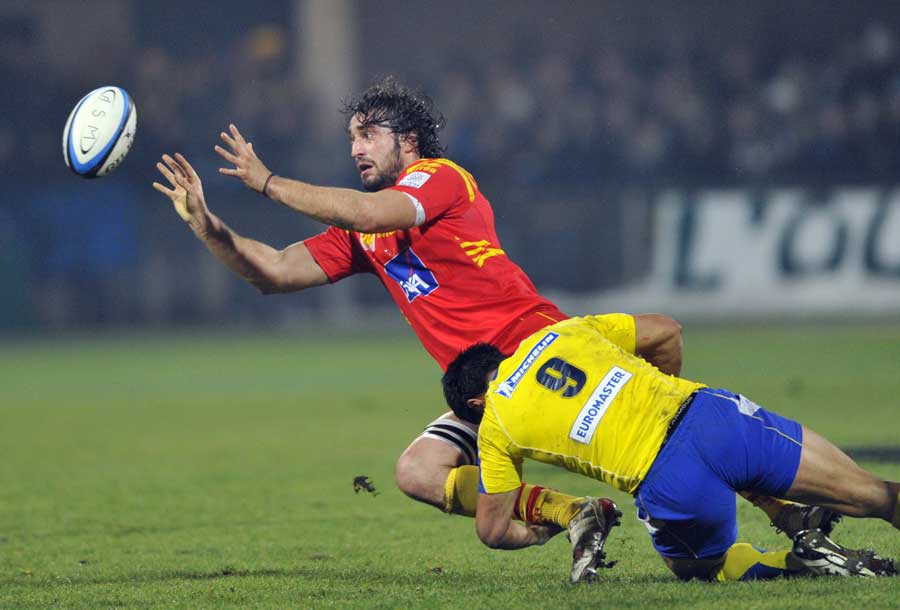 Perpignan's Bertrand Guiry is tackled by Clermont Auvergne's Kevin Senio