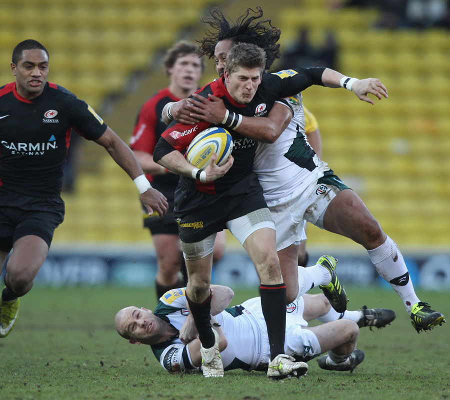 Saracens wing David Strettle is smashed by Seilala Mapusua