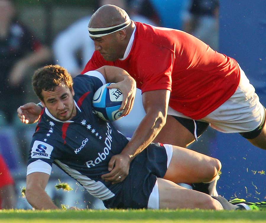 Rebels fly-half Danny Cipriani is tackled by the Tonga defence 