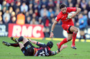 Toulouse's Clement Poitrenaud skips away from the Dragons defender