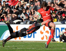 Toulouse's Maxime Medard is caught by the Dragons' defender