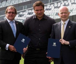 Former All Black and Rugby World Cup ambassadow Michael Jones poses with British foreign secretary William Hague (R) and New Zealand's foreign minister Murray McCully during a signing of a 'host to host agreement', Eden Park, Auckland, New Zealand, Janaury 21, 2011