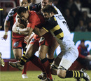 Toulon's Rudi Wulf drags two defenders with him