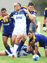 The Blues' Stephen Brett is tackled by the Highlanders' defence