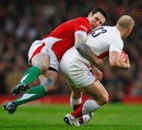 Wales' Stephen Jones tackles England's Mike Tindall