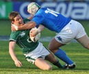 Ireland's Ronan O'Gara is tackled by Italy's Carlo Festuccia