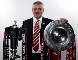 Wales coach Warren Gatland poses with the Six nations and Triple Crown trophies, March 15 2008