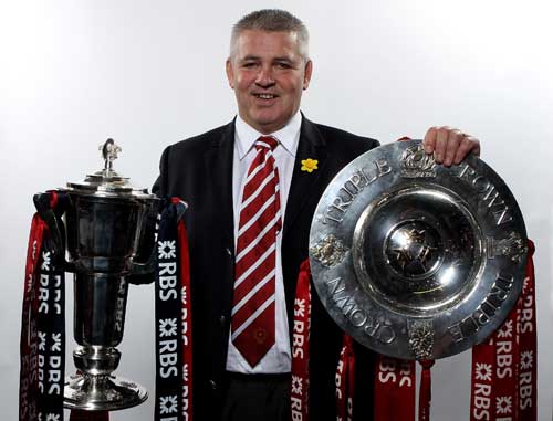 Wales coach Warren Gatland poses with the Six nations and Triple Crown trophies