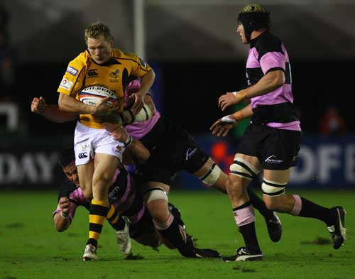 Josh Lewsey struggles with the Newcastle defence