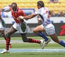 Kenya's Humphrey Kayange is tackled by Simaika Mikaele of Samoa 