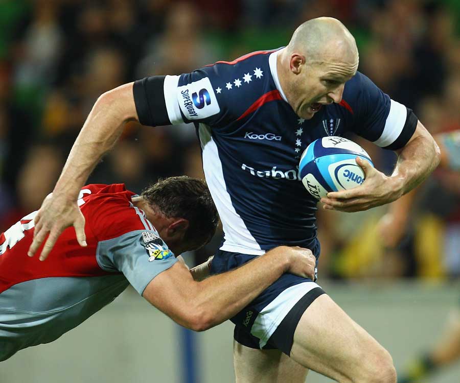 Melbourne Rebels' Stirling Mortlock tries to break the tackle against the Crusaders