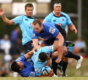 The Waratahs' Kurtley Beale is felled by the Western Force defence, Super Rugby warm-up match, Shoalhaven Rugby Park, Nowra, Australia, February 10, 2011