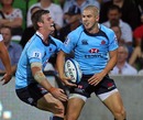 The Waratahs' Drew Mitchell is congratulated on a try