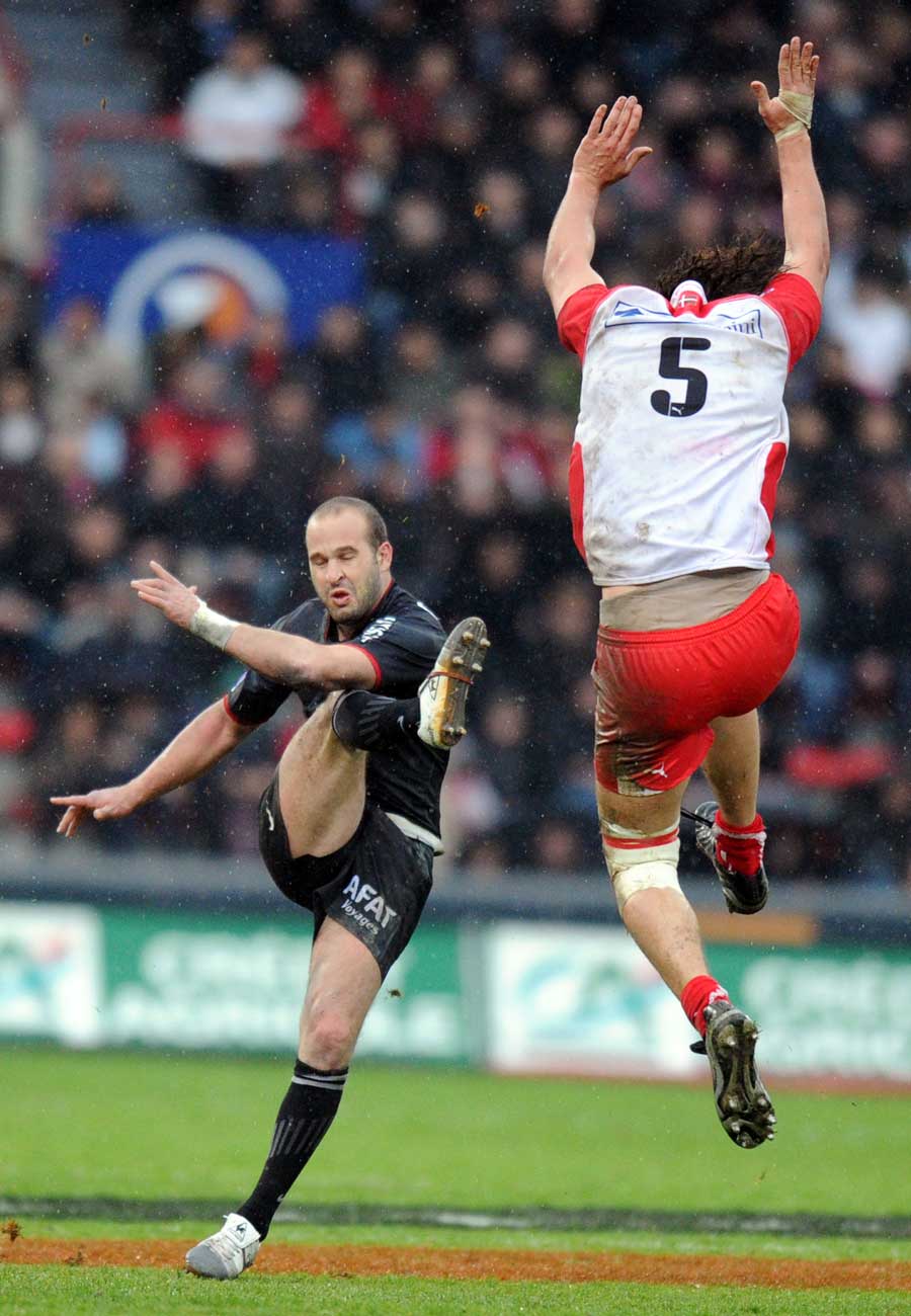Toulouse fly-half Federic Michalak launches a kick under huge pressure
