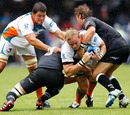 Wilhelm Steenkamp of the Sharks is tackled by two Cheetahs defenders
