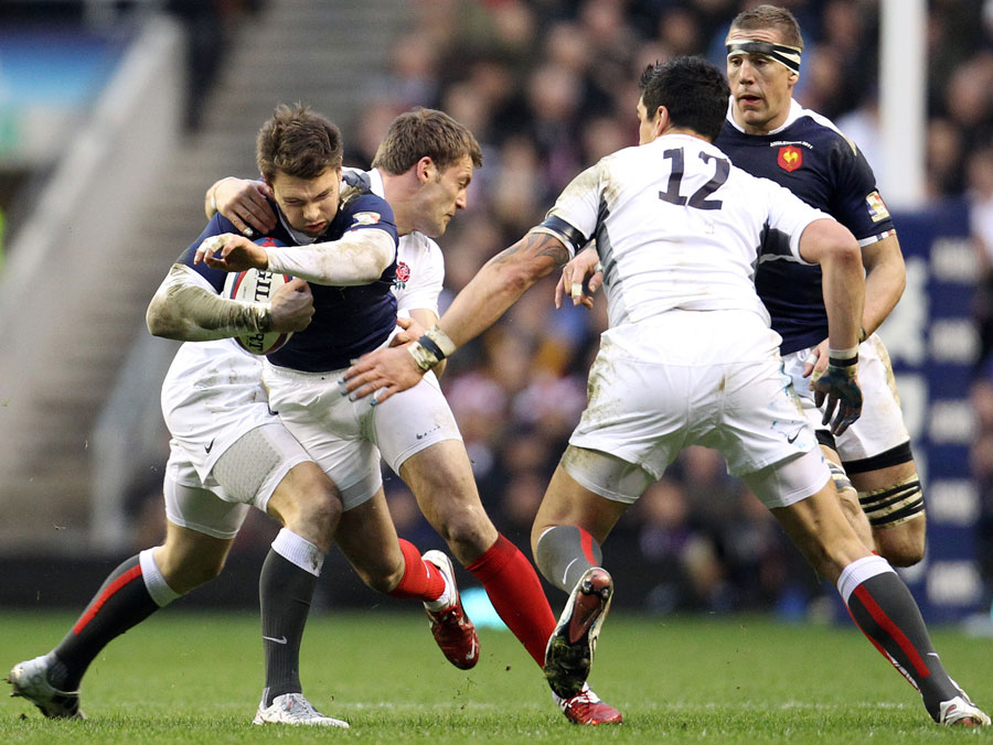 France's Vincent Clerc is tackled by fellow wing Mark Cueto