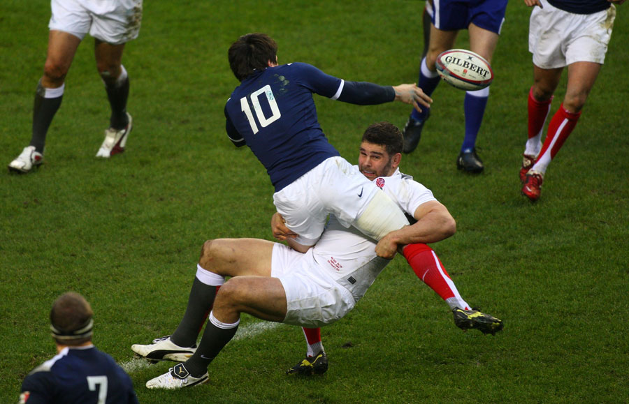 France fly-half Francois Trinh-Duc offloads in the tackle
