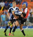 The Lions' Lionel Mapoe is stopped by Jaque Fourie of the Stormers