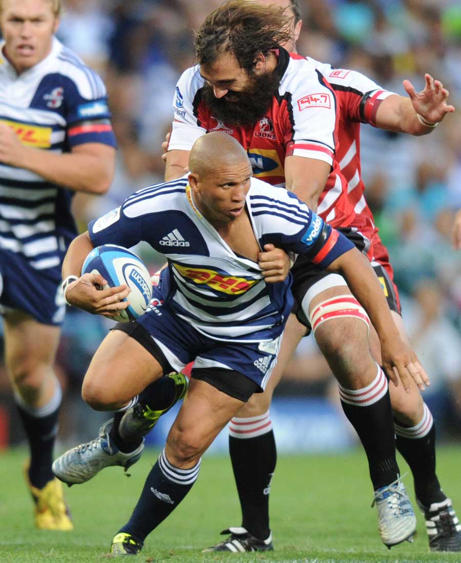The Stormers' Ricky Januarie is shackled against the Lions